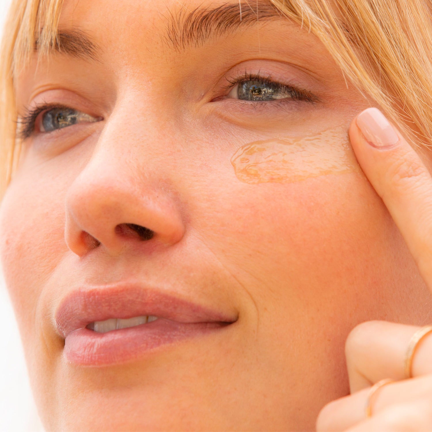 applying depuffing eye gel under eyes collectionhover