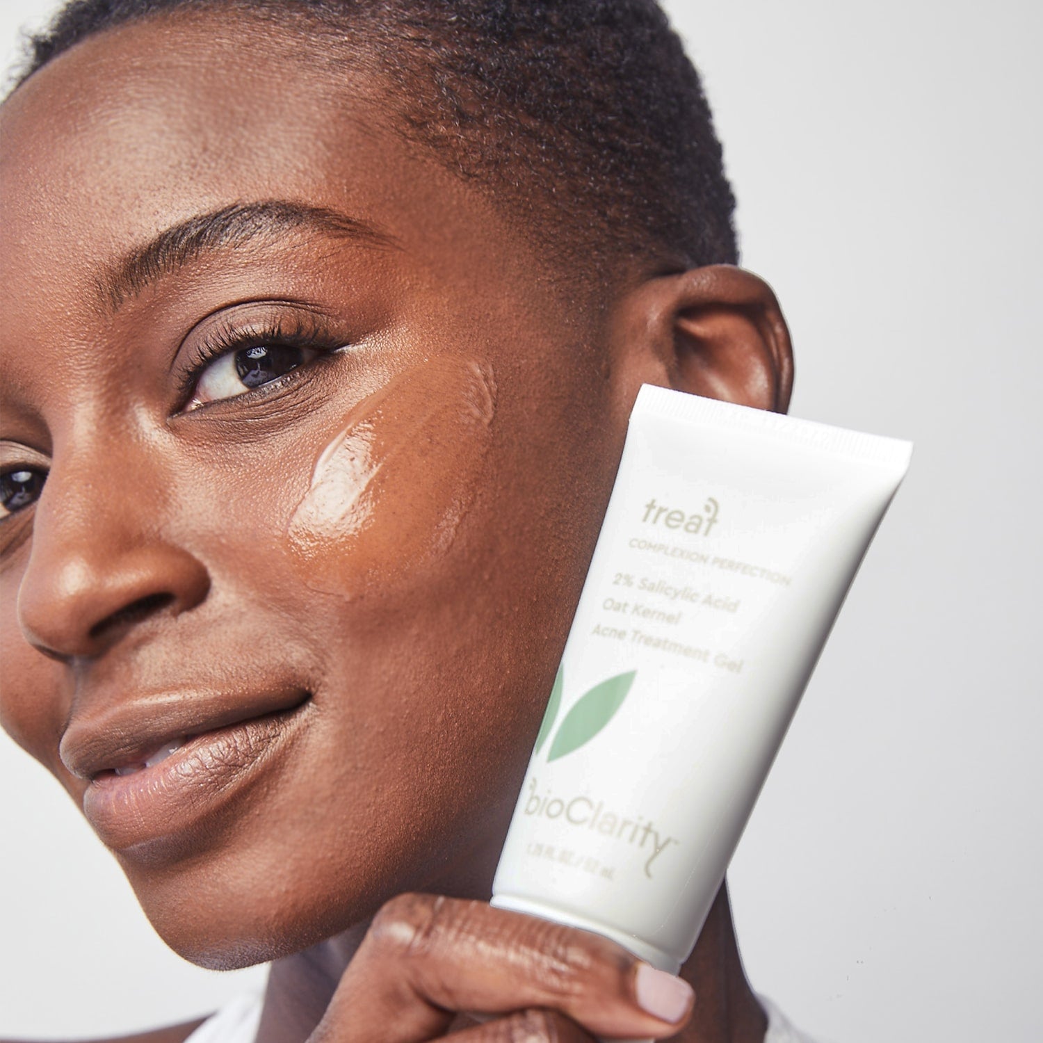 collectionhover - applying acne treatment gel on face